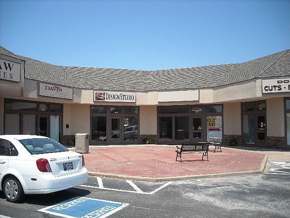 Brick courtyard with 2 benches in front of available space