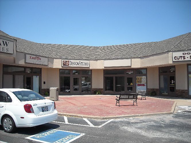 Brick courtyard with 2 benches in front of available space