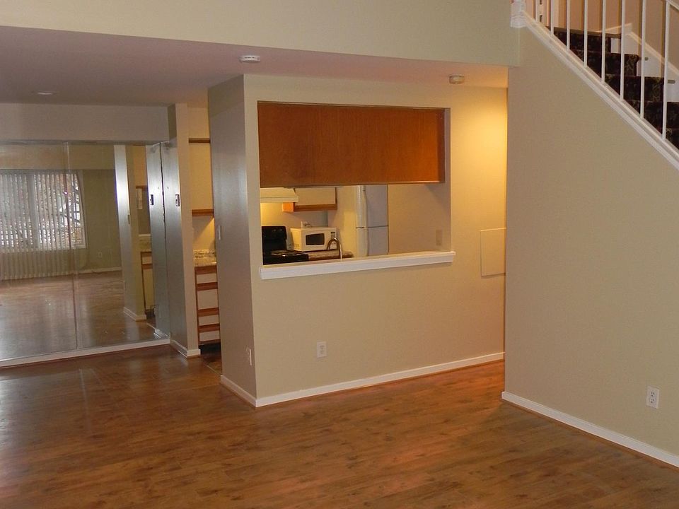 View showing living area and staircase to second bedroom