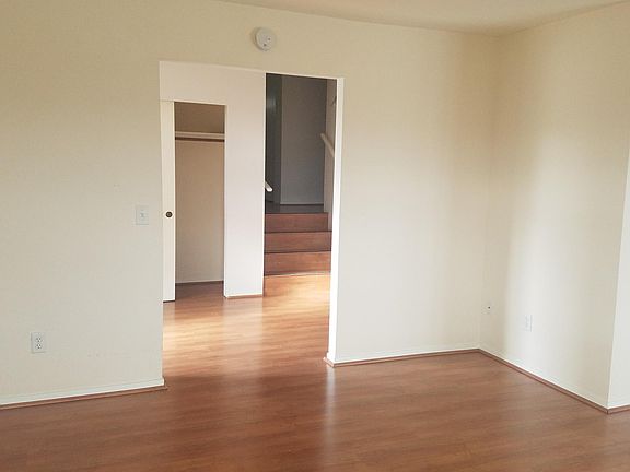 in living room looking through entry foyer up stairs to bedroom hall