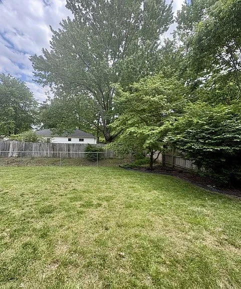 Privacy fenced backyard with established landscaping