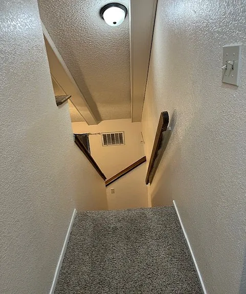 Stairs going to upper level 1 BR 1 BA + Large store room