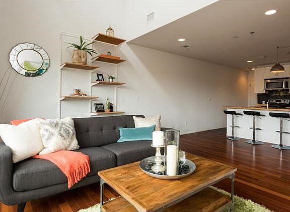 The living room has a beautiful open floor plan with plenty of natural light and high ceilings