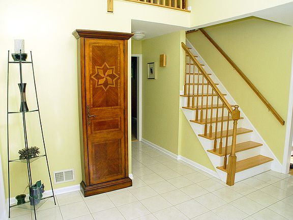 Bright, two-story foyer with ceramic tile floor