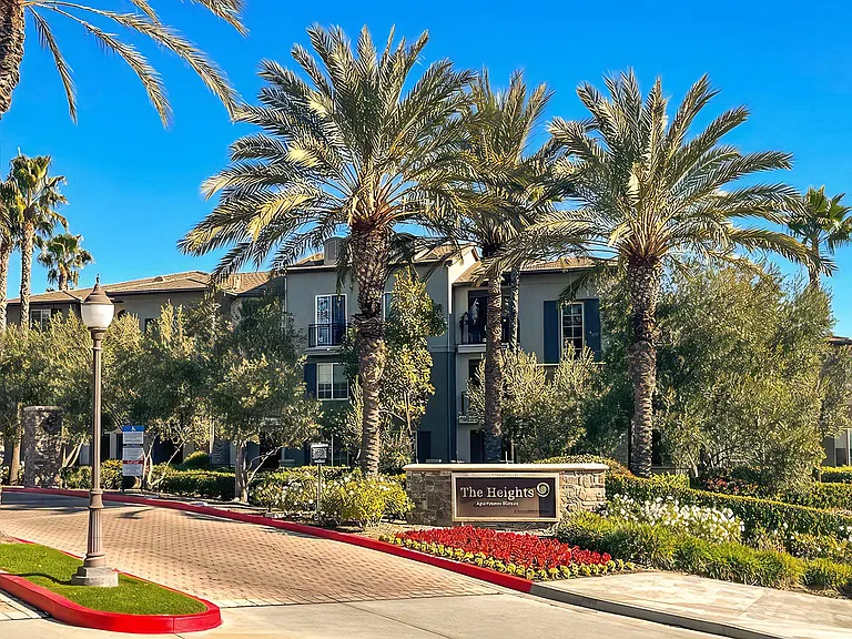 Gated Entry With Lush Landscaping and Welcome Sign
