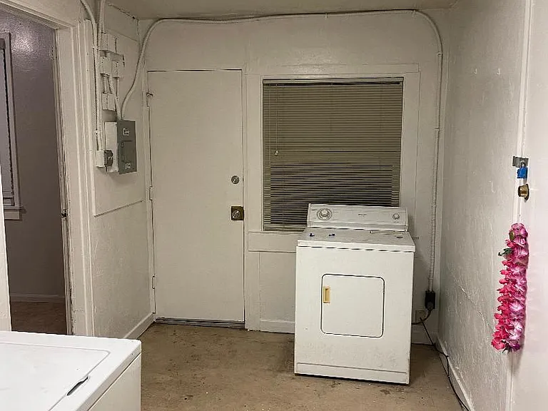 The washer and dryer are just outside the kitchen.