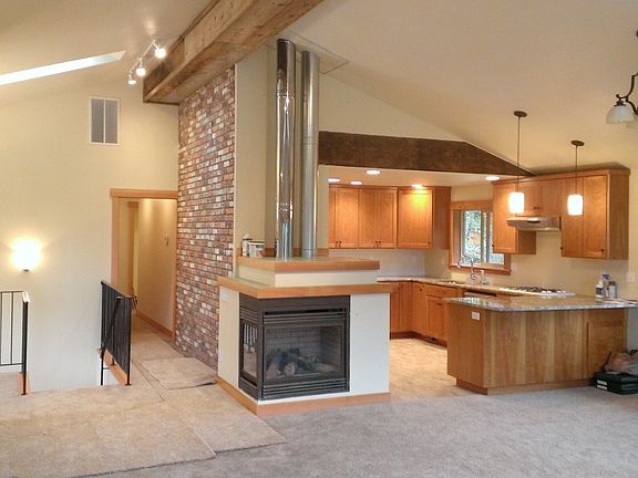 open living/dining/kitchen area w/ gas fireplace