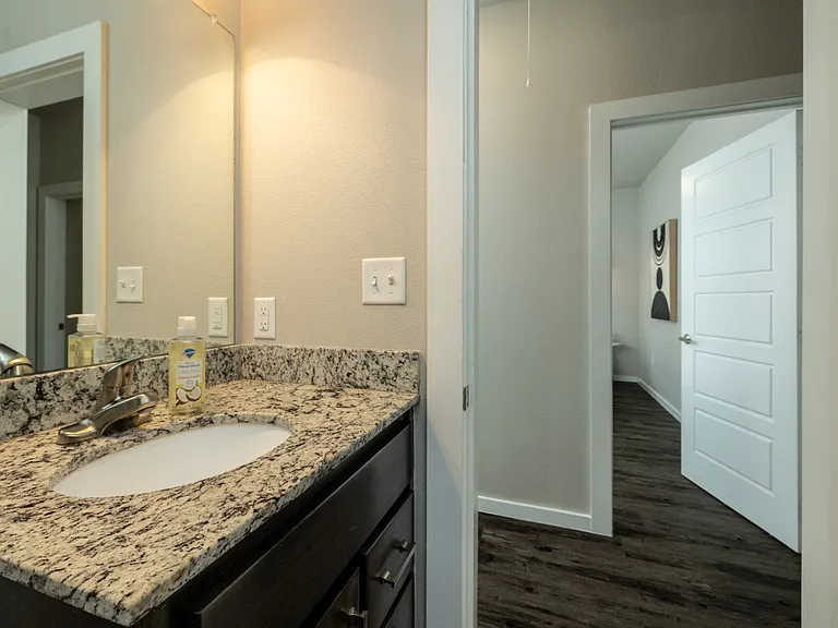 Bathroom 2 is located upstairs, it has a tub/shower combo with granite cabinet sink and mirror.