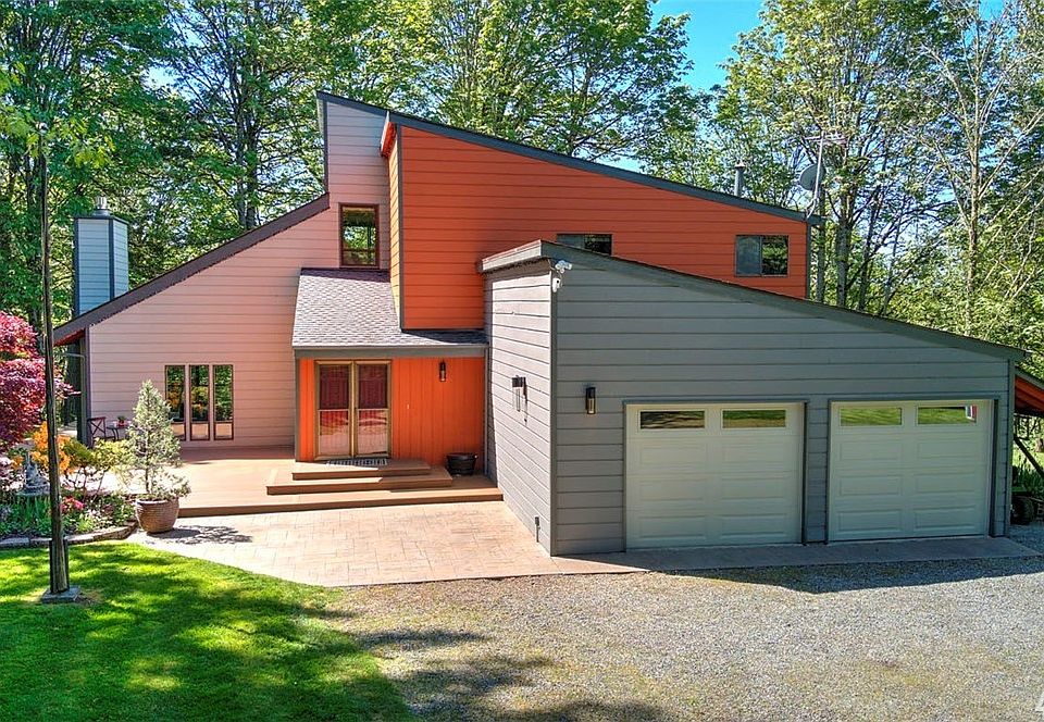 Exceptional Redmond home situated on park-like setting of flat 5-acre lot.