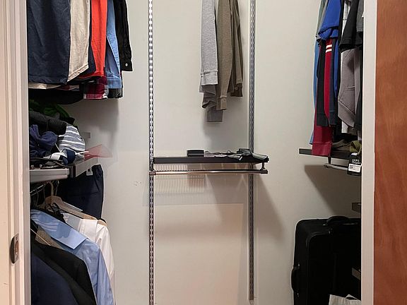 Primary bedroom walk-in closet