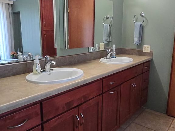 Primary Bathroom has two sinks and plenty of storage!