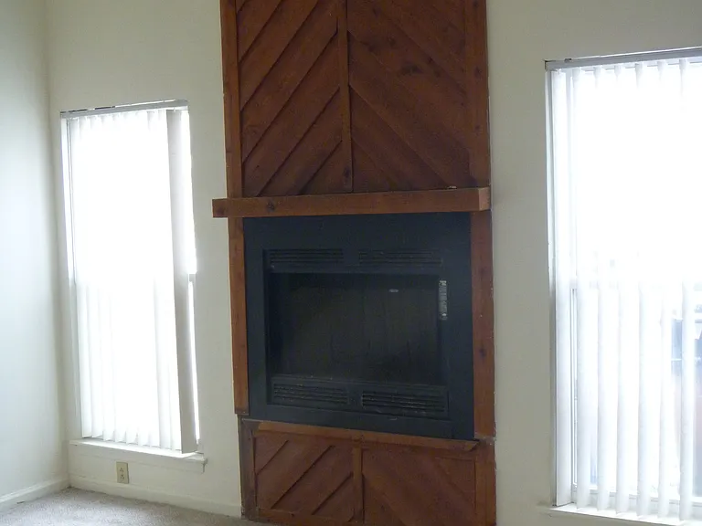 Facing front of townhouse with fireplace.