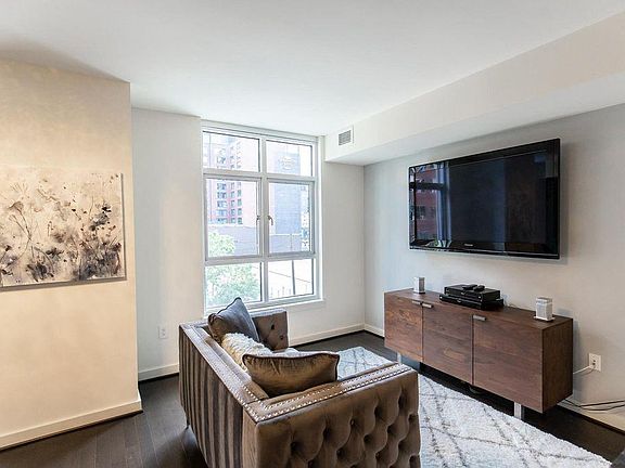 More views of the living space and the enormous TV that comes built into the unit. Unit's windows are south-facing for ample natural lighting, but not the annoying rising and setting sun that blinds you.