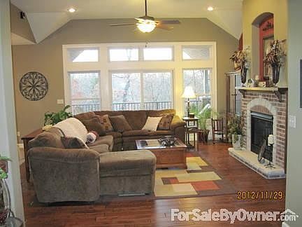 Living room
						:
						Gas fireplace with inset above, hand-scraped wood floors, transomes, great view.