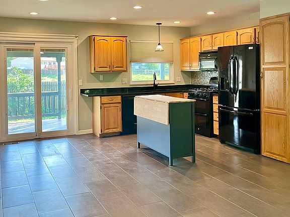 Kitchen/Dining Area walks out to covered deck and fenced back yard