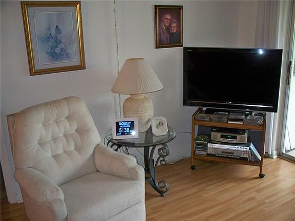 Living room with sliders to the covered screened porch