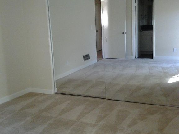 Master bedroom with mirrored doors for the large closet