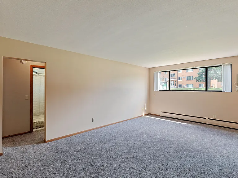 Living room with wall unit air conditioning