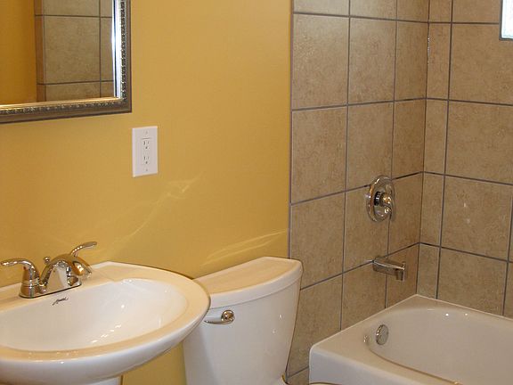Ceramic tile bathroom. Glass block window provides natural light and privacy .