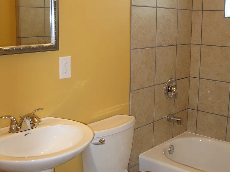 Ceramic tile bathroom. Glass block window provides natural light and privacy .