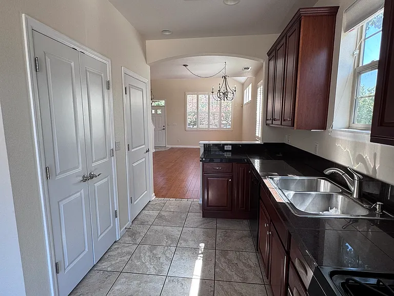 Kitchen: the doors to the left include a large pantry and stacked washer/dryer)