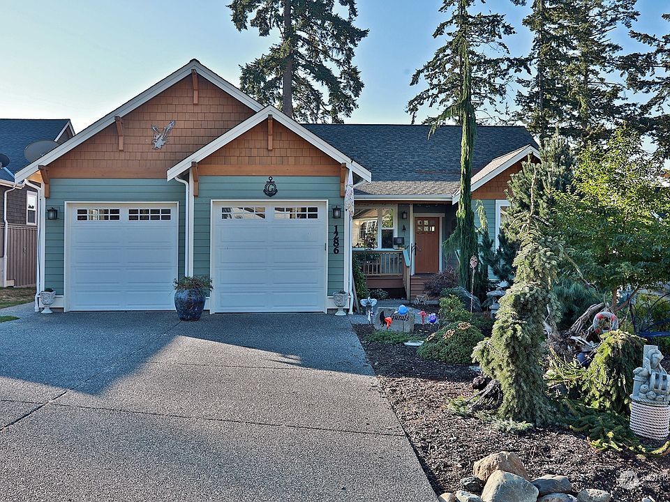 Two car garage with entry from the garage into the laundry/mud room. There is also a door from the garage to the outside on the east side of the garage. Mature low maintenance landscaping. >