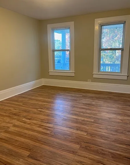 Living room which is adjacent to second floor balcony.