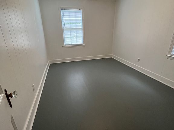 Bedroom with ceiling fan, two windows and a closet.