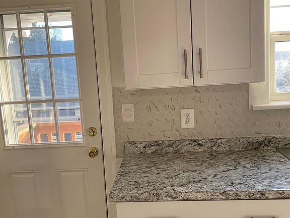 Kitchen with side door to outside and backyard