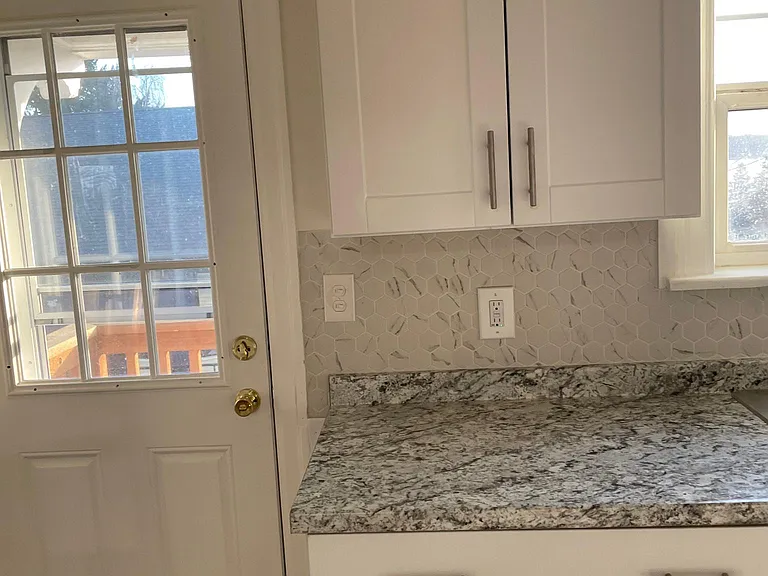 Kitchen with side door to outside and backyard