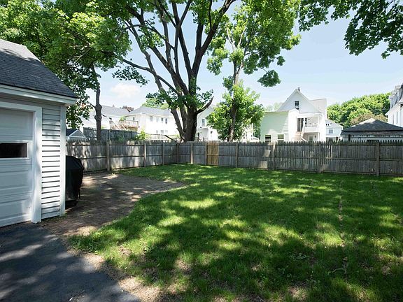Fenced in backyard with patio