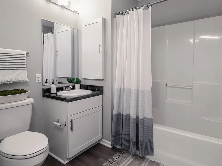 Enjoy the clean, modern aesthetics of our bathrooms featuring wood-style flooring.