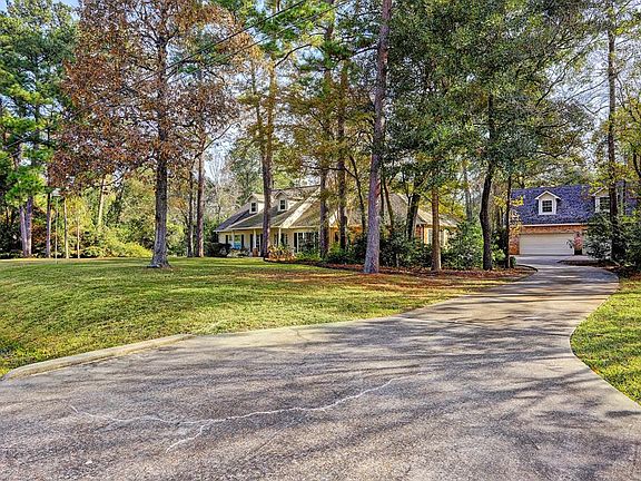 Generous long driveway leading up to this four bay garage with plenty of parking for all!