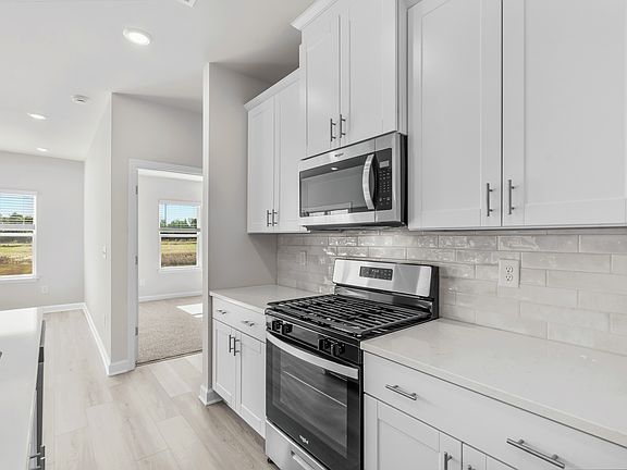 The first floor primary suite is located off of the kitchen.