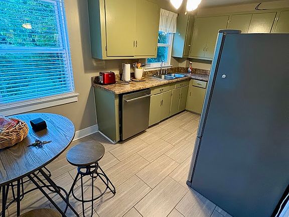 Kitchen area has table and chairs. New dishwasher.