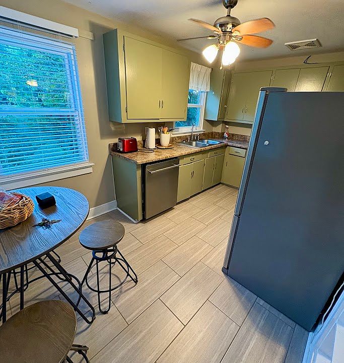 Kitchen area has table and chairs. New dishwasher.