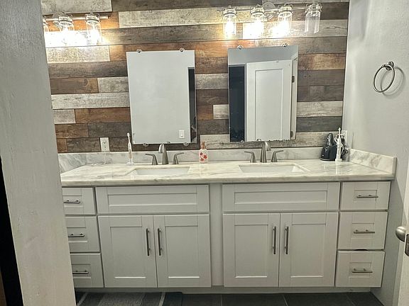 Primary bathroom with dual sinks and vanity area