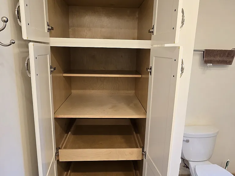Linen Cabinet features pull-out shelving