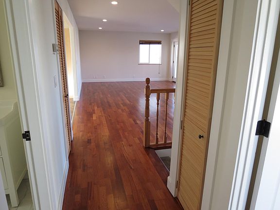 Looking toward living room on the main floor. Full bath on the left, bedroom on the right with views and French door to deck and one more bedroom behind facing the back yard