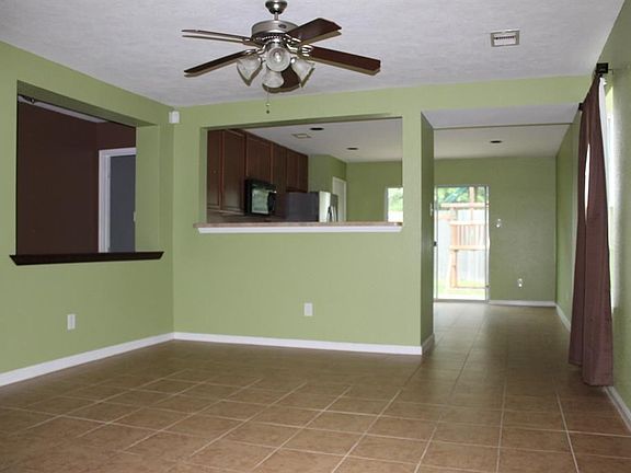 ANOTHER VIEW OF ENTRY WAY OF LIVING ROOM AND KITCHEN .