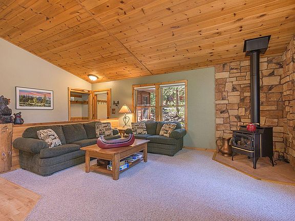 Sitting area with pull-out couch and gas fire view stove. New HVAC energy efficient installed 2018 with an average monthly SW Gas heating bill of $88-$100 during winter ski season of 2021.