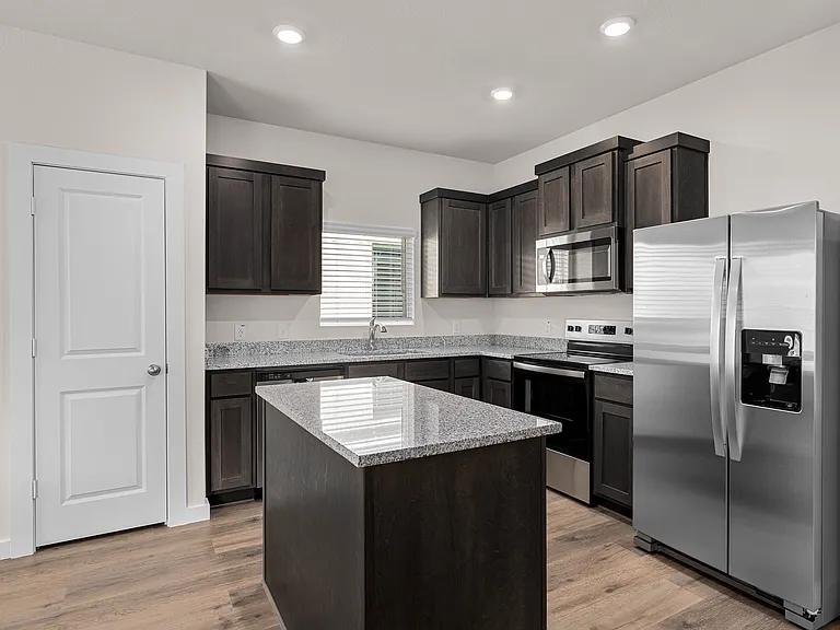 The kitchen has beautiful wood cabinetry.
