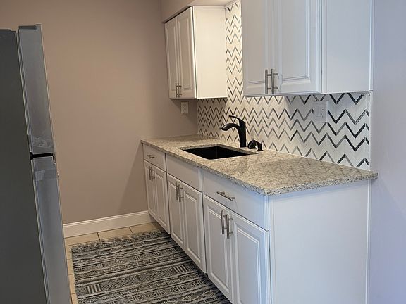 Kitchen. New cabinets, counter top, and sink.