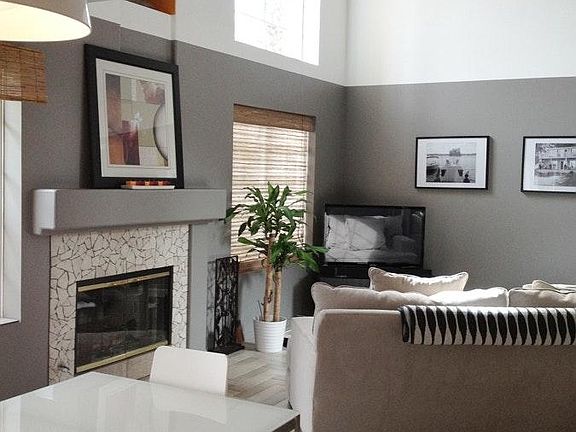 Modern, stylish living room with large windows & fireplace