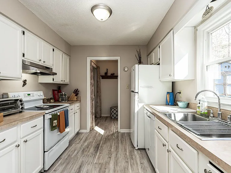 Laundry area located at the back of the kitchen complete with iron, ironing board and all supplies needed for laundry.