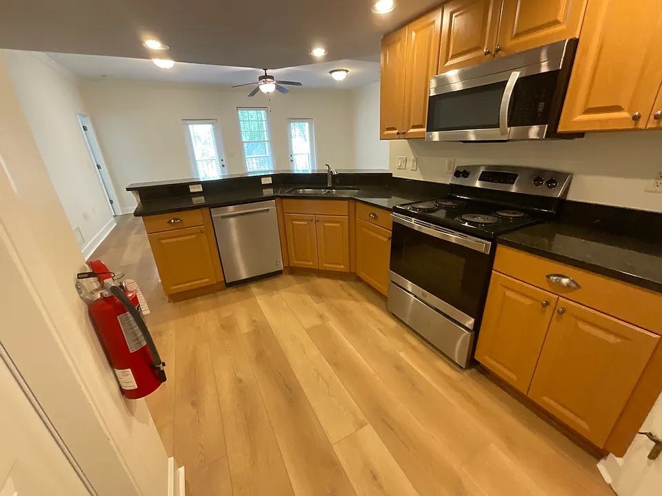 Large kitchen with granite and stainless steel appliances and walk-in pantry