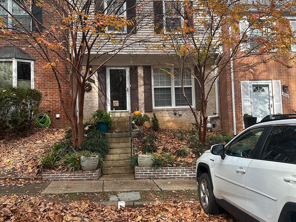 Low maintenance front garden shaded in Summer by Natchez crepe myrtles. Community workers will clear fallen leaves.