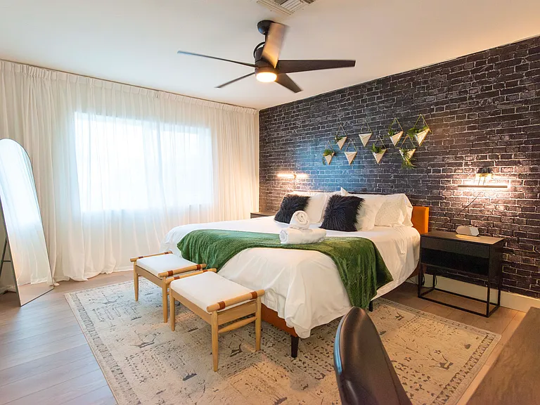 Second master with private bath and King sized bed. This bedroom also has a work desk and television.
