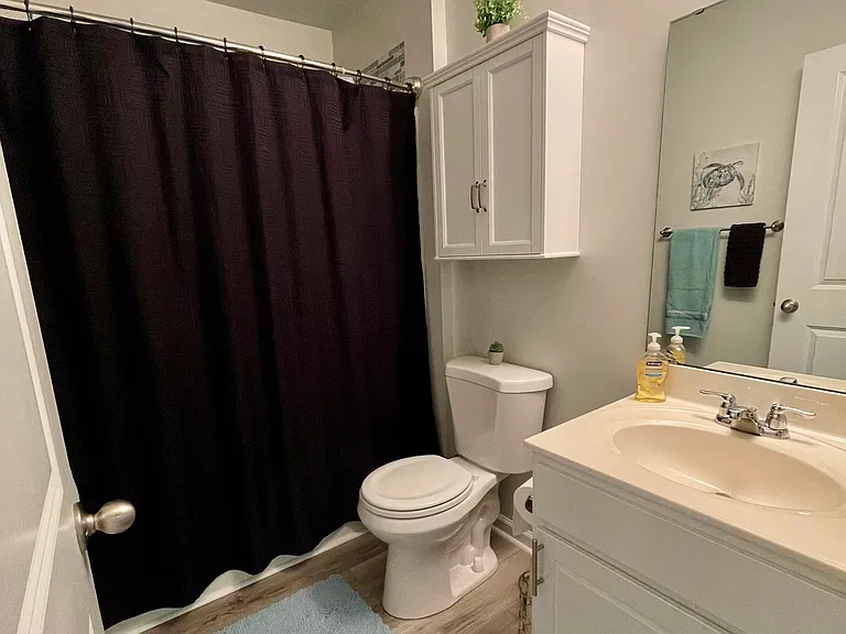 View of full bath from doorway, with storage under sink & medicine cabinet over toilet. Keep decor now or decorate it your way.