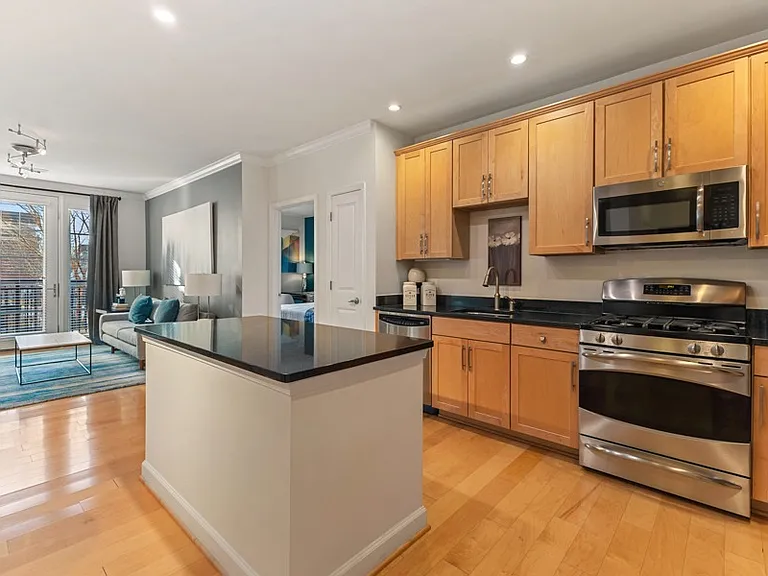 Gourmet kitchens with wood cabinets, granite countertops, and stainless steel appliances